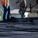 Construction,Workers,In,Safety,Gear,With,Shovels,And,Asphalt,Rakes